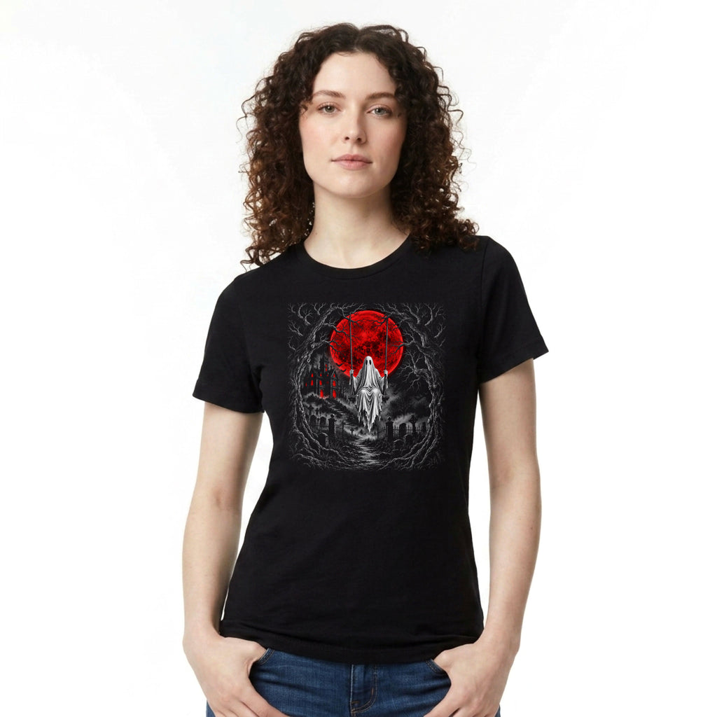 A woman with curly brown hair wearing a black short-sleeve graphic t-shirt with a red and white design on the chest, paired with blue jeans, against a plain white background.