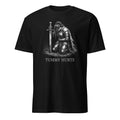 A black short-sleeve crewneck t-shirt featuring a white graphic of a kneeling armored knight holding a sword, with the text 'TUMMY HURTS' printed below, shown against a plain white background.