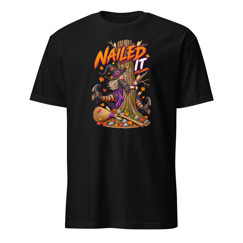 A black short-sleeve crewneck t-shirt featuring a colorful graphic of a witch with a broomstick and the text 'Nailed It' in orange and yellow, displayed on a clean white background.