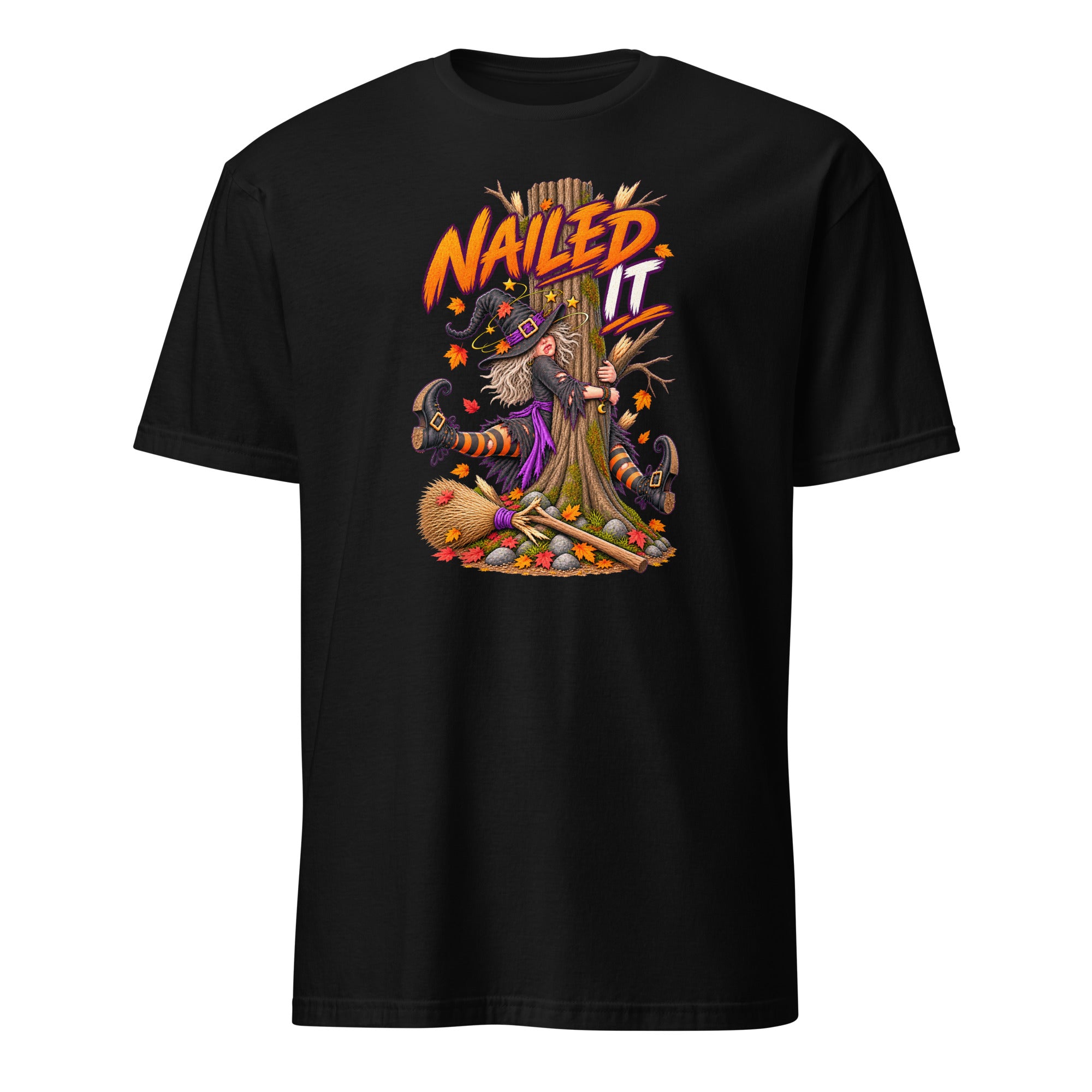 A black short-sleeve crewneck t-shirt featuring a colorful graphic of a witch with a broomstick and the text 'Nailed It' in orange and yellow, displayed on a clean white background.