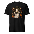 A black short-sleeve crewneck t-shirt featuring a detailed graphic print of a ghostly figure in a white sheet sitting on a throne and reading a book, surrounded by Halloween decorations like pumpkins, skulls, and candles.