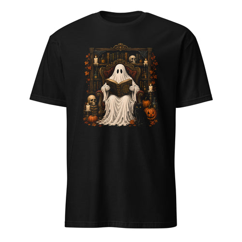 A black short-sleeve crewneck t-shirt featuring a detailed graphic print of a ghostly figure in a white sheet sitting on a throne and reading a book, surrounded by Halloween decorations like pumpkins, skulls, and candles.