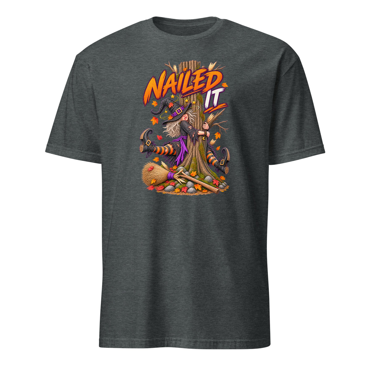 A dark heather gray short-sleeve t-shirt with a colorful graphic on the front showing a witch nailed to a tree stump with the text 'NAILED IT' in orange and white.
