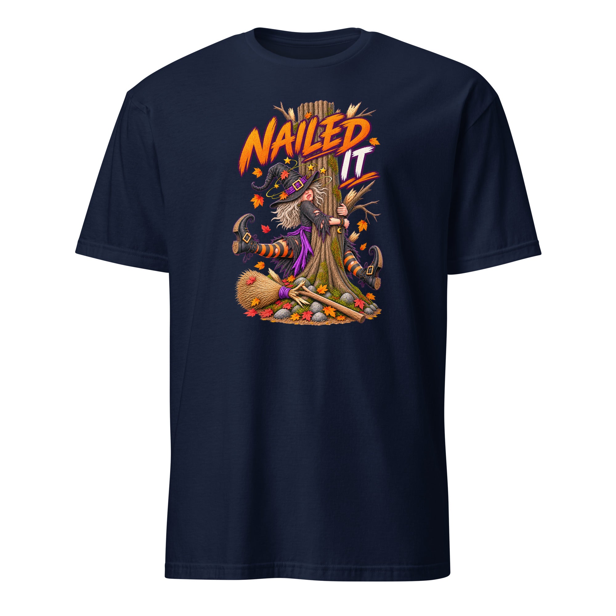 A navy blue short-sleeve crewneck t-shirt featuring a colorful graphic print on the front. The graphic shows a witch riding a broomstick with the text 'NAILD IT' in orange and yellow, surrounded by autumn and Halloween elements like a broom, pumpkin, and acorns.