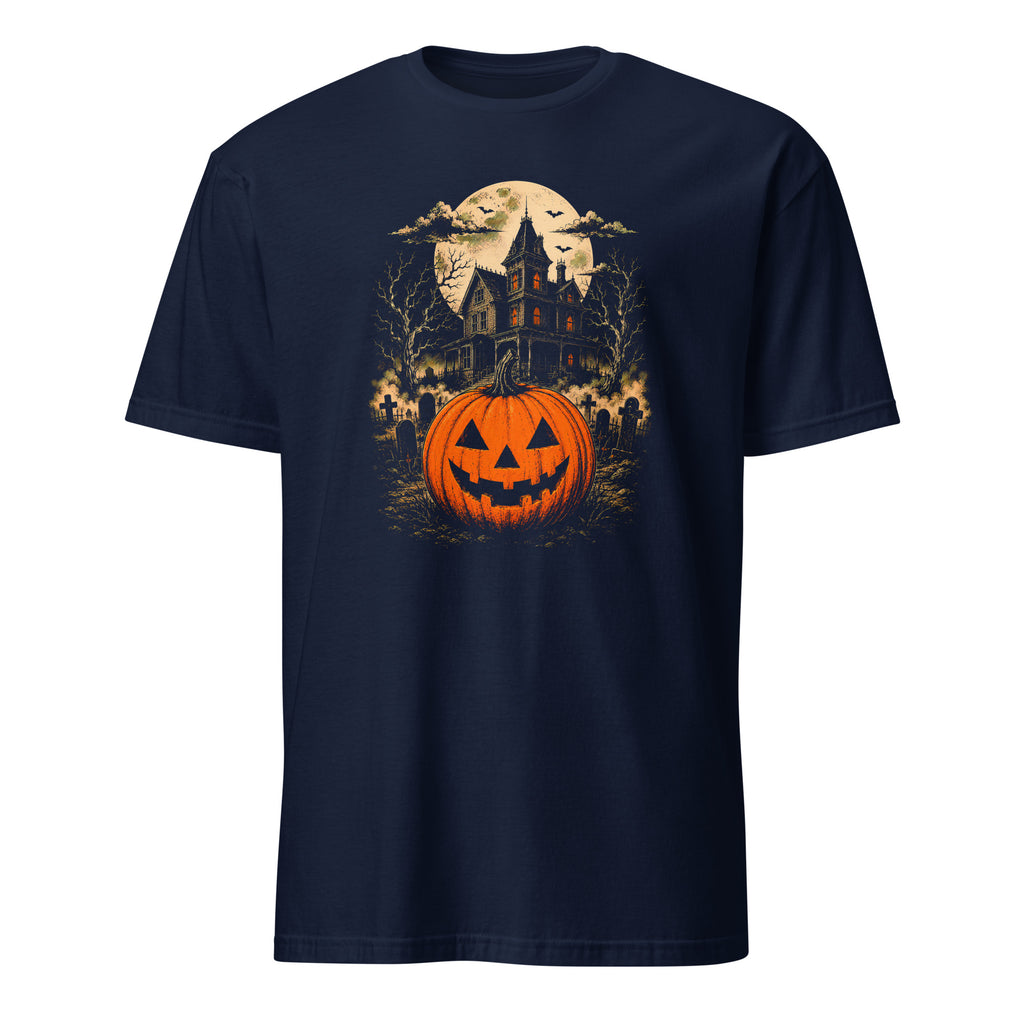A navy blue short-sleeve crewneck t-shirt featuring a detailed Halloween graphic print on the front. The graphic depicts a glowing orange jack-o'-lantern pumpkin in the foreground, set against a spooky haunted house, bare trees, a full moon, and bats.