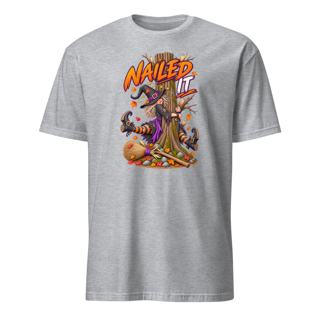 A heather gray short-sleeve crewneck t-shirt featuring a colorful graphic of a witch hanging from a tree with the text 'NAIL IT' in orange and yellow.