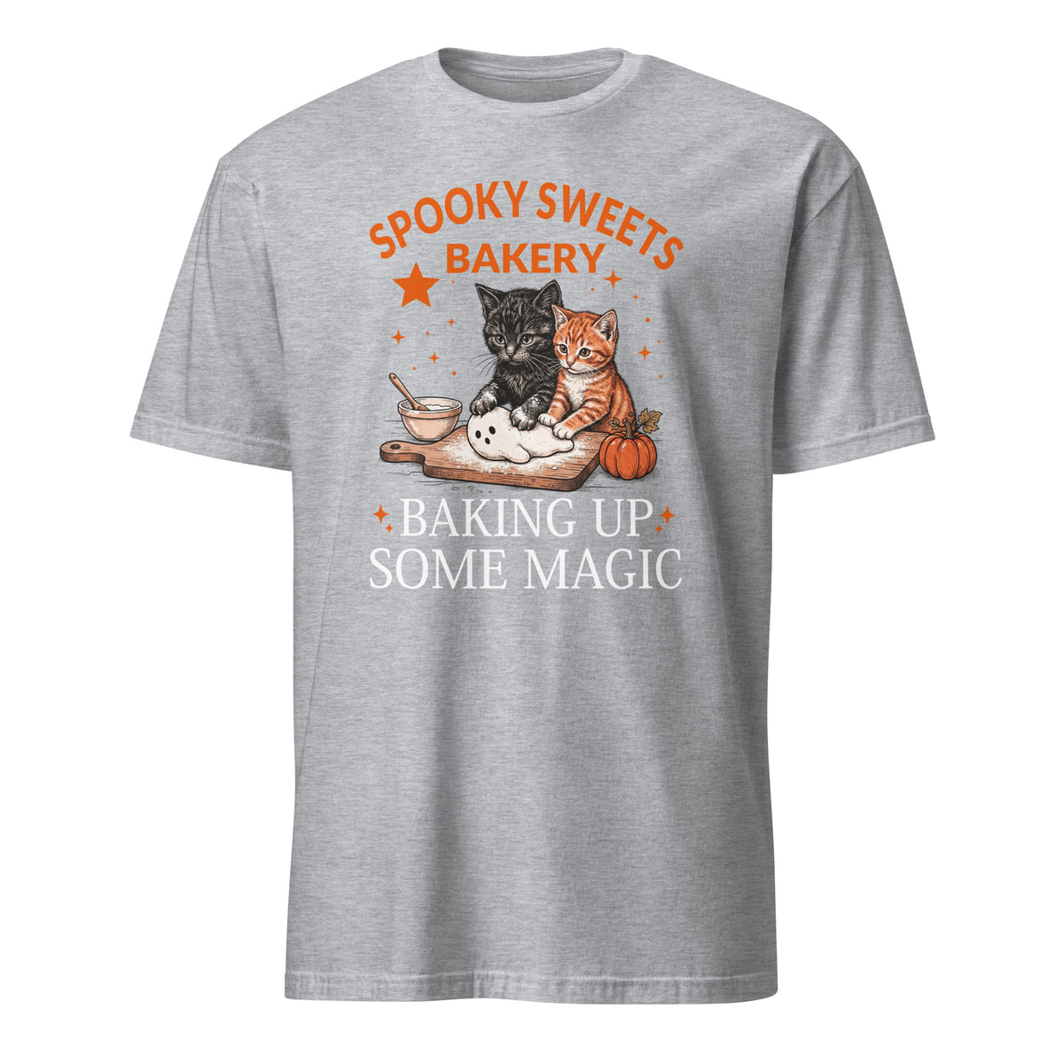 A heather gray short-sleeve t-shirt with a graphic on the front featuring two cats baking with the text 'SPOOKY SWEETS BAKERY' and 'BAKING UP SOME MAGIC'.