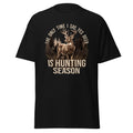 A black short-sleeve t-shirt with a graphic print of a deer in a forest and the text 'THE ONLY TIME I SAY YES DEER IS HUNTING SEASON' in beige, shown on a plain white background.