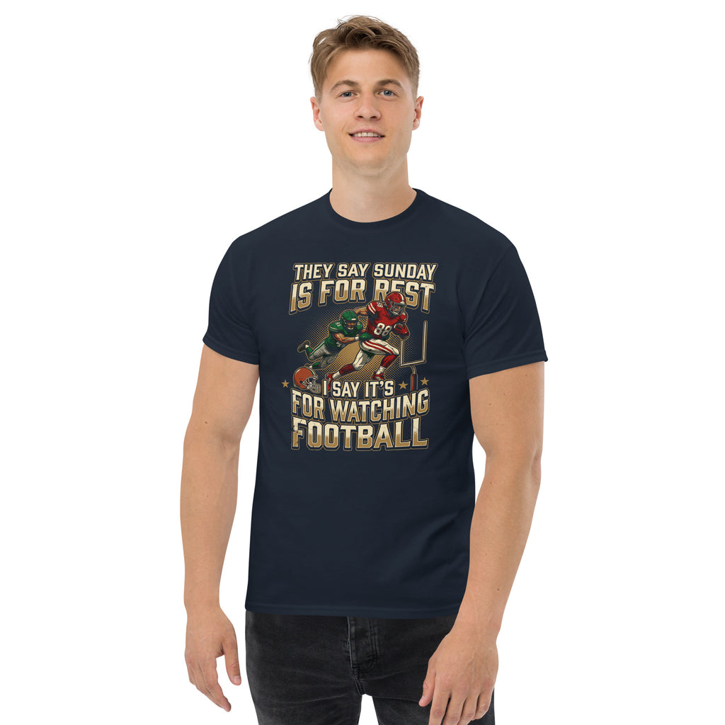 Man wearing a navy blue t-shirt with a graphic design of two football players.