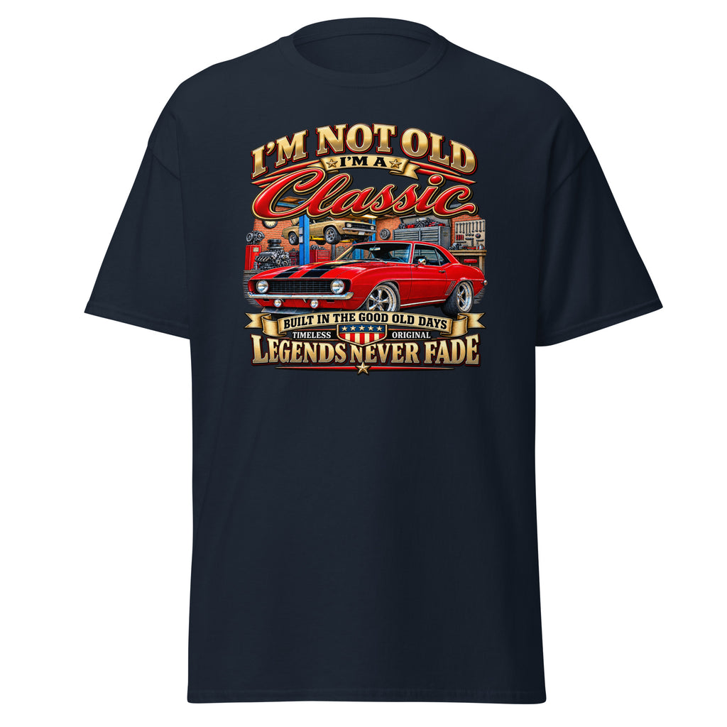 A navy blue short-sleeve t-shirt with a large graphic print on the front. The graphic features a red classic muscle car and stylized text reading 'I'M NOT OLD I'M Classic' and 'LEGENDS NEVER FADE'.