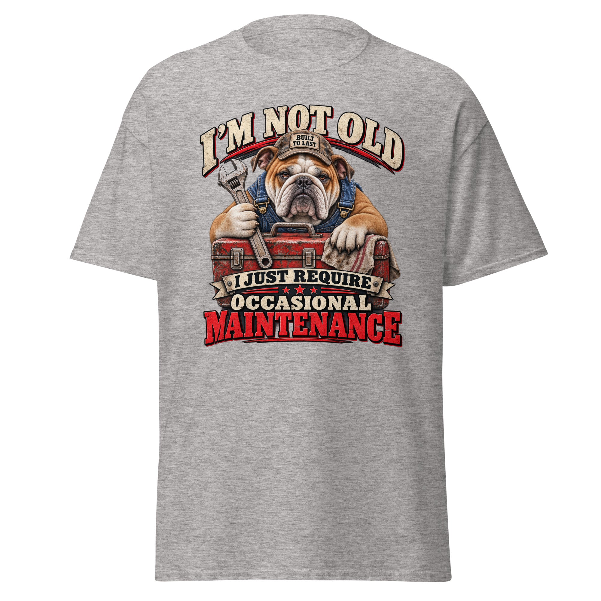 A heather gray short-sleeve t-shirt shown from the back, featuring a large graphic print of an English Bulldog wearing a mechanic's hat and holding a wrench over a red toolbox, with the text 'I'M NOT OLD I JUST REQUIRE OCCASIONAL MAINTENANCE'.