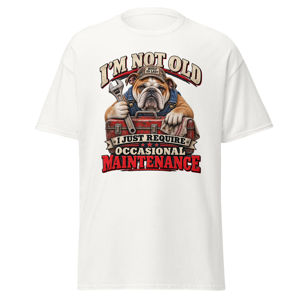 A white short-sleeve crewneck t-shirt featuring a large graphic print of an bulldog wearing a mechanic's hat and holding a wrench over a red toolbox, with the text 'I'M NOT OLD I JUST REQUIRE OCCASIONAL MAINTENANCE'.